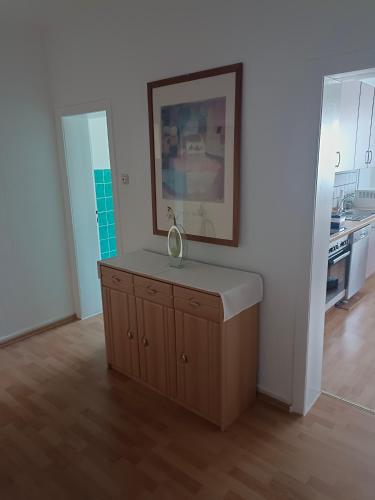 a kitchen with a dresser with a mirror on it at Nette Kuschelige Terrassen Wohnung in Bochum