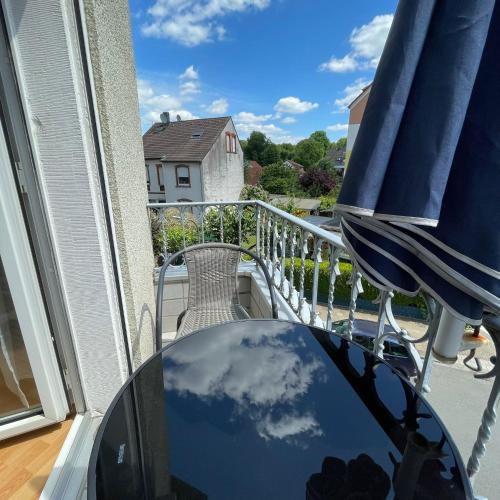 a reflection of the sky in a glass table on a balcony at Nette Kuschelige Terrassen Wohnung in Bochum