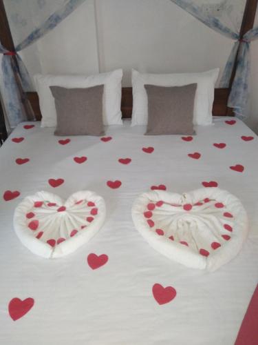 a bed with hearts painted on the sheets at SILVER RAIL in Galle