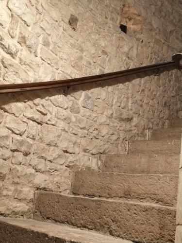 a stone wall with stairs in front of it at Les 2 Tours in Chenay