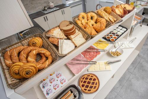 a buffet filled with different types of bread and pastries at Amea Baku Hotel in Baku