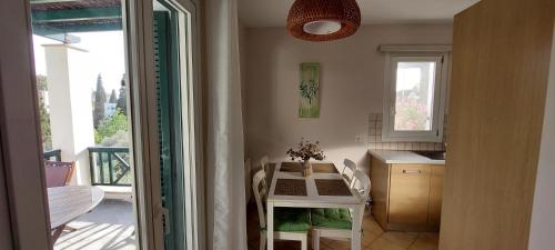 a small kitchen with a table and a table and a window at Mpatsi Sunset House in Batsi