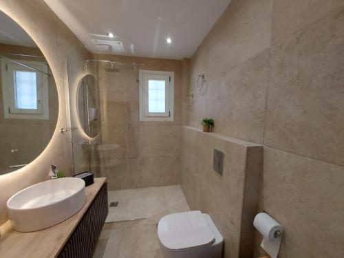 a bathroom with a sink and a toilet at Mpatsi Sunset House in Batsi