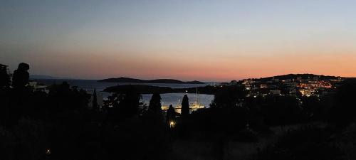 a view of a city and the ocean at sunset at Mpatsi Sunset House in Batsi