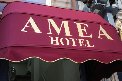 a sign for a amar hotel on a building at Amea Baku Hotel in Baku