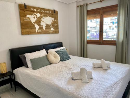 a bedroom with a bed with two towels on it at La Mata beach apartment Viñamar I, 200m from the beach in La Mata