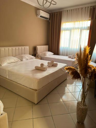 a bedroom with two beds with towels on them at ErLi Apartment in Shkodër