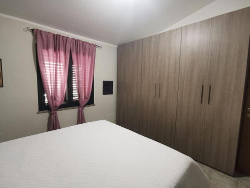 Кровать или кровати в номере Appartamento le Magnolie