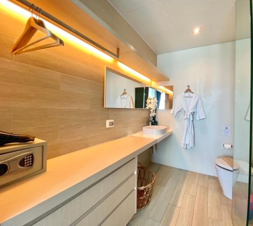 a bathroom with a counter with a sink and a mirror at Veranda Residence pattaya By Sea in Jomtien Beach