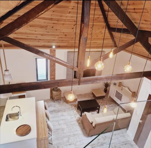 a living room with wooden ceilings and a couch at Loft beach in Vieira de Leiria