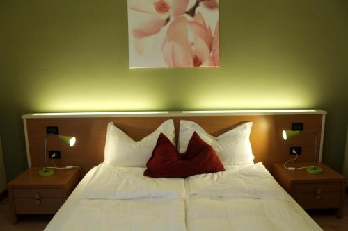 a bedroom with a bed with two pillows on it at Ely'S Residence in Romano D'Ezzelino