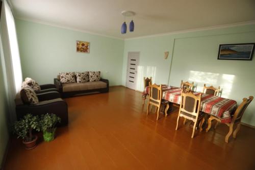 a living room with a table and a couch at David B&B in Sisian