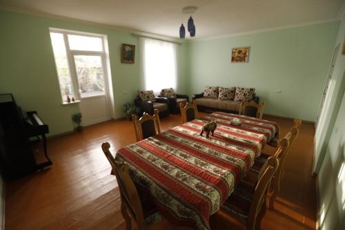 a living room with a table with a cat sitting on it at David B&B in Sisian