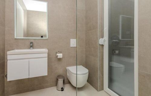 a bathroom with a toilet and a glass shower at Residence Doli Pool in Vrsi