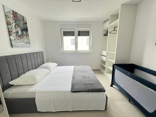 a bedroom with a large bed and a window at Residence Doli Pool in Vrsi