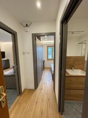 a bathroom with a tub and a sink in a room at Trilocale nel centro storico di Bormio in Bormio