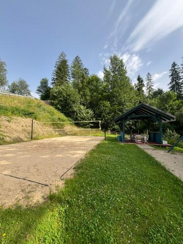 a gazebo in a park next to a field at Apartamenty Lavender Hill in Wisła