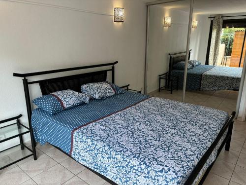 une chambre avec un lit avec une couette bleue dans l'établissement Appartement proche de la mer, à Sainte-Marie-la-Mer