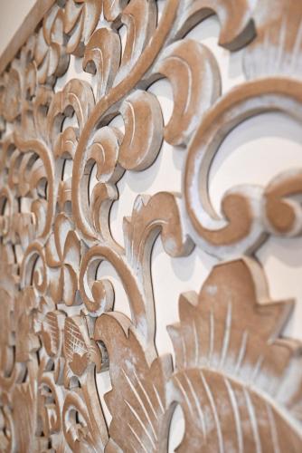 a close up of a wooden carving on a wall at The Cloisters Bed And Breakfast in Xagħra