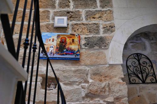 a picture on the side of a stone wall at The Cloisters Bed And Breakfast in Xagħra