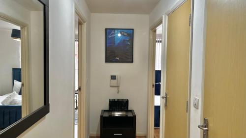 a hallway with a mirror and a room with a bed at City Centre 1 Bedroom Cozy Apt - With Balcony in Birmingham