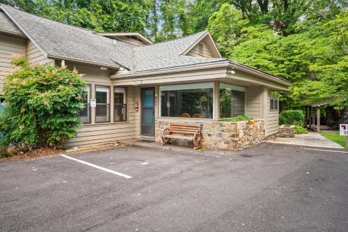 a house with a parking lot in front of it at Carr's Northside Hotel and Cottages in Gatlinburg