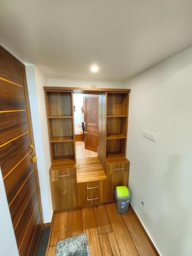 a room with wooden shelves and a door at Tranquil Home in Trivandrum