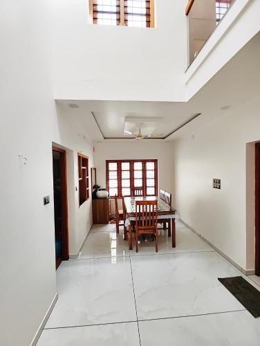 a dining room with a table and chairs at Tranquil Home in Trivandrum