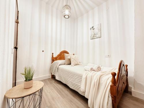 a bedroom with a bed and a table at Casa Rural Puebla Deluxe l Privacidad e intimidad in Puebla de Alcocer