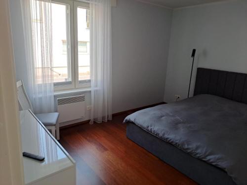 a small bedroom with a bed and a window at Tolli 12 Apartment in Kuressaare