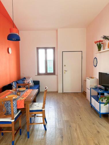a living room with a table and a couch at Casa Giù in Cecina