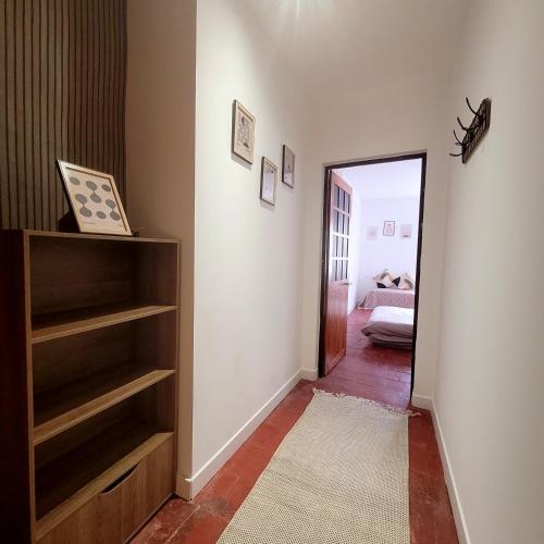 a hallway with a door leading to a bedroom at Jolie maison de vacances 4-5 personnes in Saint-Marcel