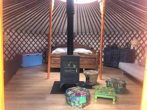 a room with a wood stove in a yurt at Iloons yurt in Hollandscheveld