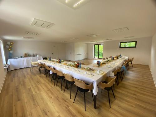 a large room with a long table and chairs at Miejska Stodoła in Biała Podlaska