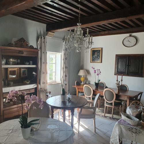 un salon avec une table et une salle à manger dans l'établissement L'Aumônerie, à Liesle