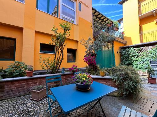 a blue table and chairs in front of a building at Il cortiletto by Alterego in Villanova dʼAsti