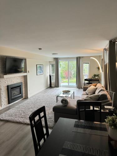 a living room with a couch and a fireplace at Bright private suite near Departure Bay beach in Nanaimo