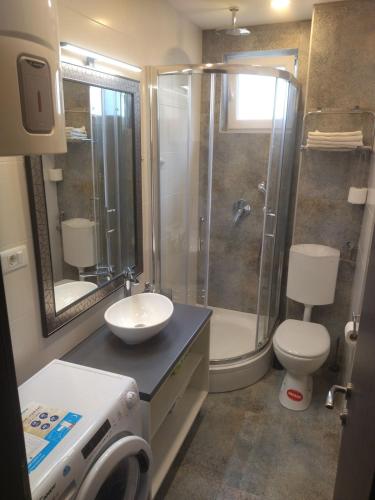 a bathroom with a shower and a sink and a toilet at Apartment Miranda in Brela