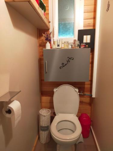 une salle de bain avec des toilettes blanches dans une chambre dans l'établissement Chalet Domaine de Marcilly, à Marcilly-sur-Eure