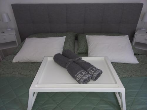 a pair of mittens sitting on a table on a bed at Ferienwohnung Detox in Payerbach