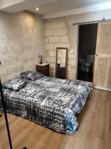 une chambre avec un lit et un mur en pierre dans l'établissement Cosy studio, à Avignon