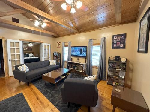 a living room with a couch and a table at Chez Le Fleur in Scott