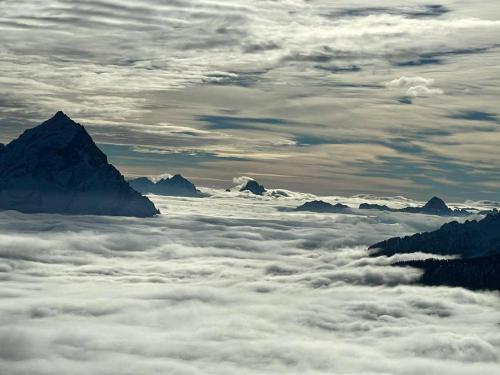 a view from above the clouds with mountains and glaciers at Casa Elena in Pieve di Cadore