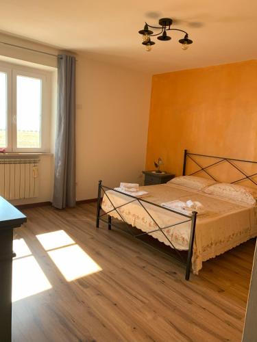 a bedroom with a bed and a window at Casalebellavista in Tarquinia