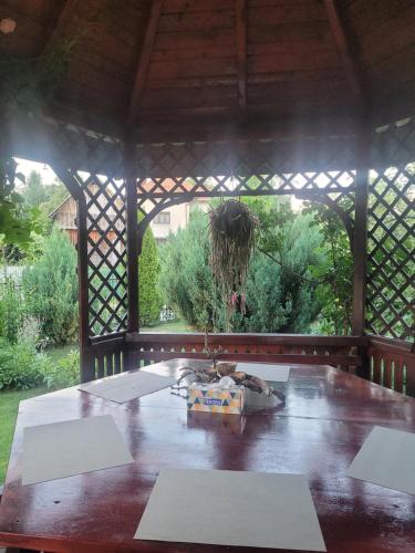 a wooden table in a wooden gazebo with at Pensiunea Diana in Arefu