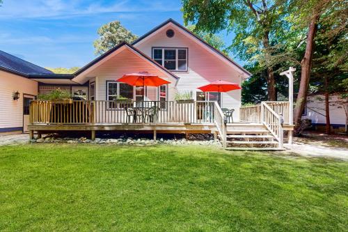 a house with a deck with two red umbrellas at Savannahs Landing - 6 Mary Elizabeth in Ocean View