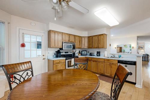 a kitchen with a wooden table and a dining room at Savannahs Landing - 6 Mary Elizabeth in Ocean View