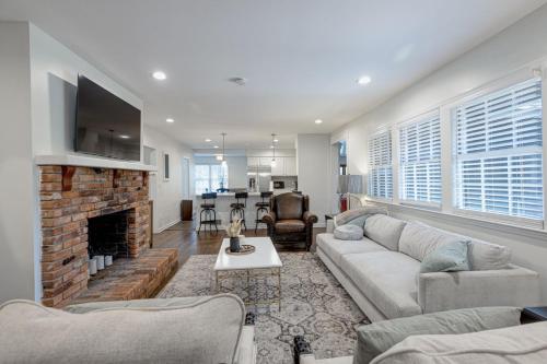 a living room with a couch and a fireplace at Group Getaway 6BR Near Fort Benning Huge Kitchen Private Yard in Columbus
