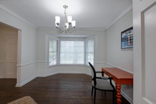 a dining room with a desk and a window at Group Getaway 6BR Near Fort Benning Huge Kitchen Private Yard in Columbus