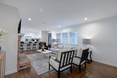 a living room with a couch and a table at Group Getaway 6BR Near Fort Benning Huge Kitchen Private Yard in Columbus